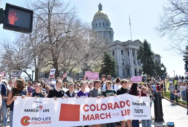 Students and supporters carrying the Colorado March for Life banner
