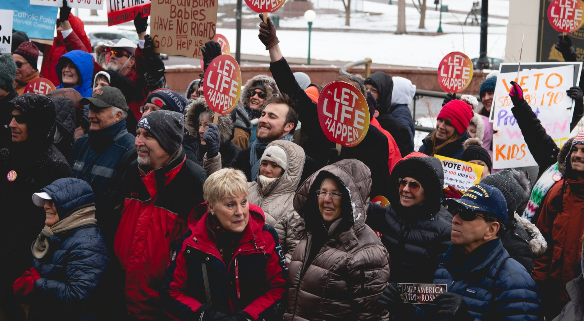Supporters holding Let Life Happen signs in the snow